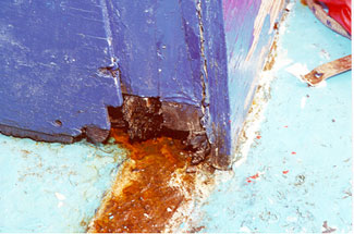 Photo 10 - Disintegration due to dry rot of inboard base of bridge front door frame (outboard base similar)